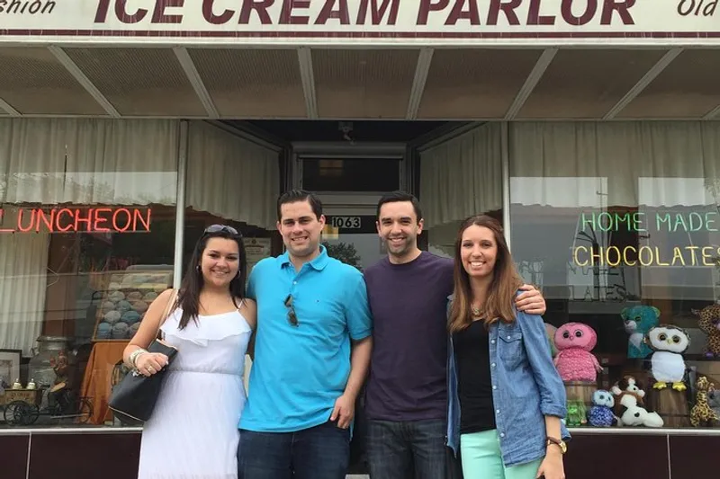 Actor guide with a small group beside a diner on a Sopranos filming locations New York bus tour in New Jersey