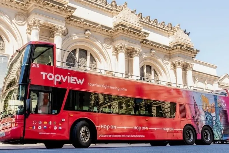 Open-top double-decker on a New York bus tour with a TopView hop-on hop-off pass near Times Square