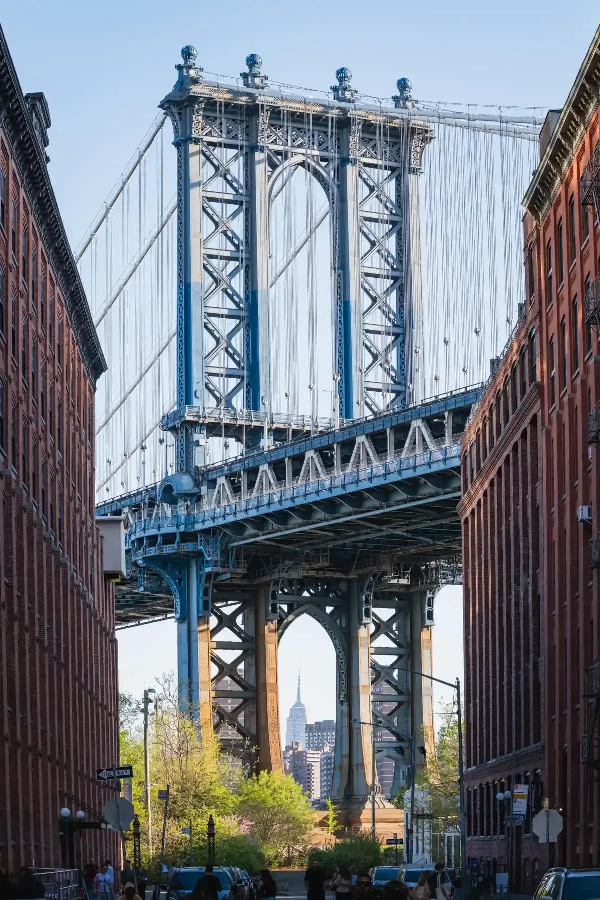 The Manhattan Bridge framed by brick warehouses on Washington Street in DUMBO, a stop on guided NYC bus tours to Brooklyn